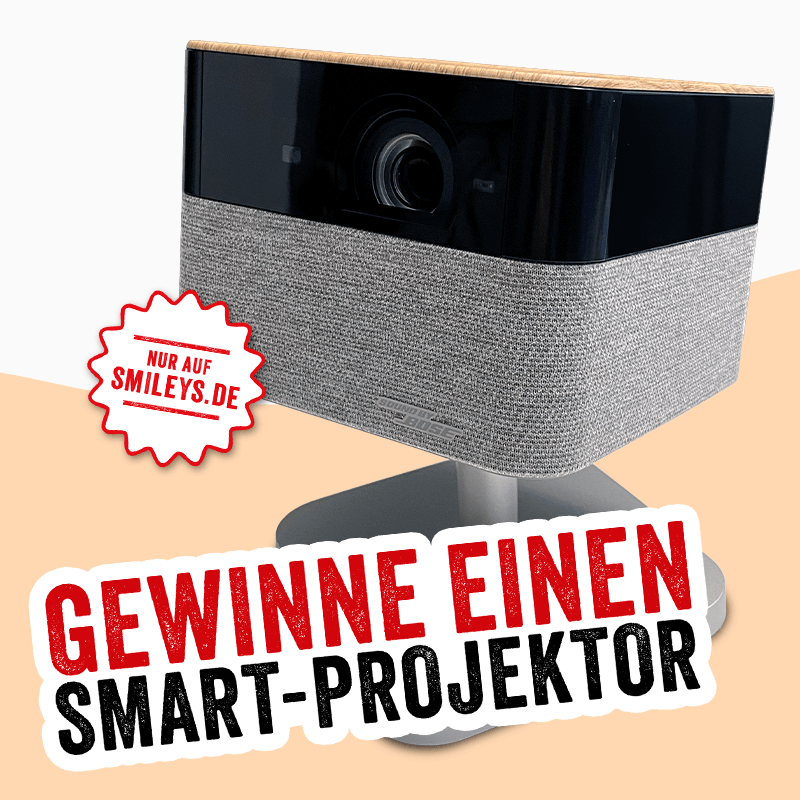 Gewinnspielmotiv mit einem Smart-Projektor auf Standfuß. Text im Bild: „Gewinne einen Smart-Projektor“ sowie der Hinweis „Nur auf smileys.de“.